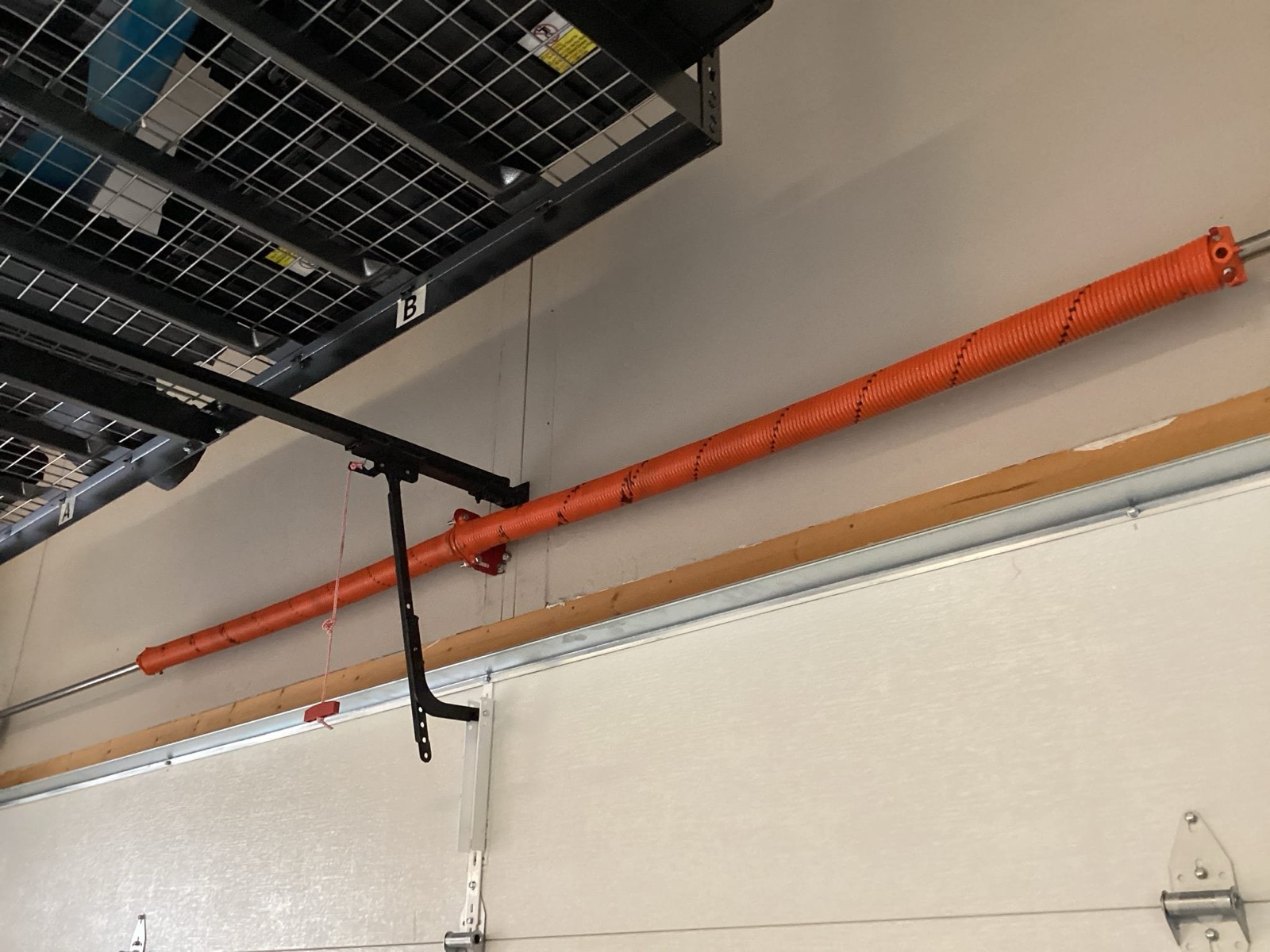 Freshly installed torsion springs on a garage door, balanced and safe