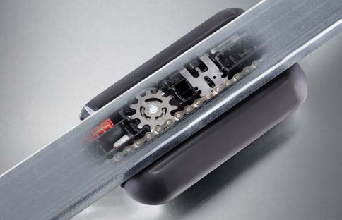 Close-up of the Sommer evo+ Direct Drive carriage — the traveling motor and steel sprocket that glide along a fixed chain, the opener's only moving part